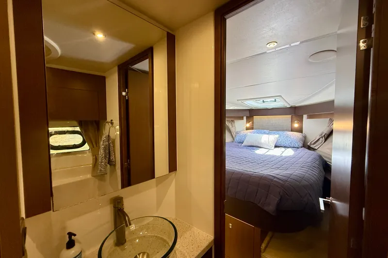 Slide: The Image of Luxurious interior of 2016 Sea Ray Sundancer 400 yacht, featuring a cozy bedroom and modern bathroom. - 41