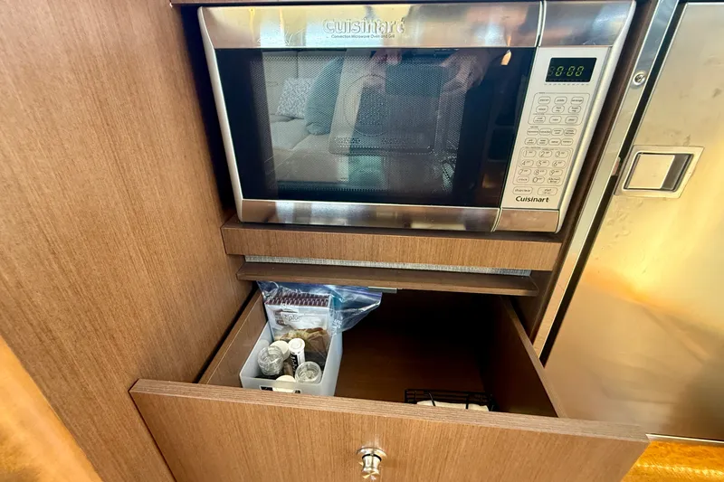 Slide: The Image of Microwave and storage drawer in 2016 Sea Ray Sundancer 400 yacht kitchen. - 25
