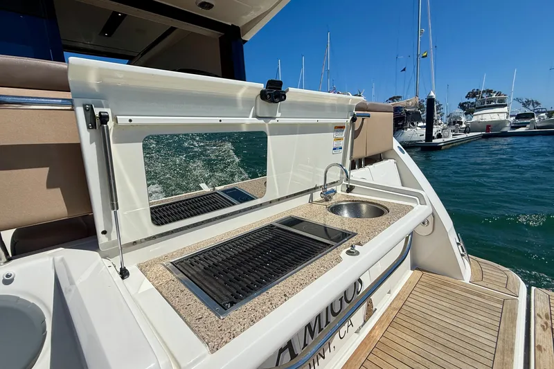Slide: The Image of Outdoor kitchenette on 2016 Sea Ray Sundancer 400 yacht, featuring sink and grill by marina. - 53