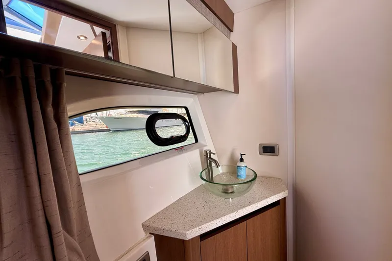 Slide: The Image of Luxurious bathroom interior of 2016 Sea Ray Sundancer 400 yacht with glass sink and ocean view. - 44