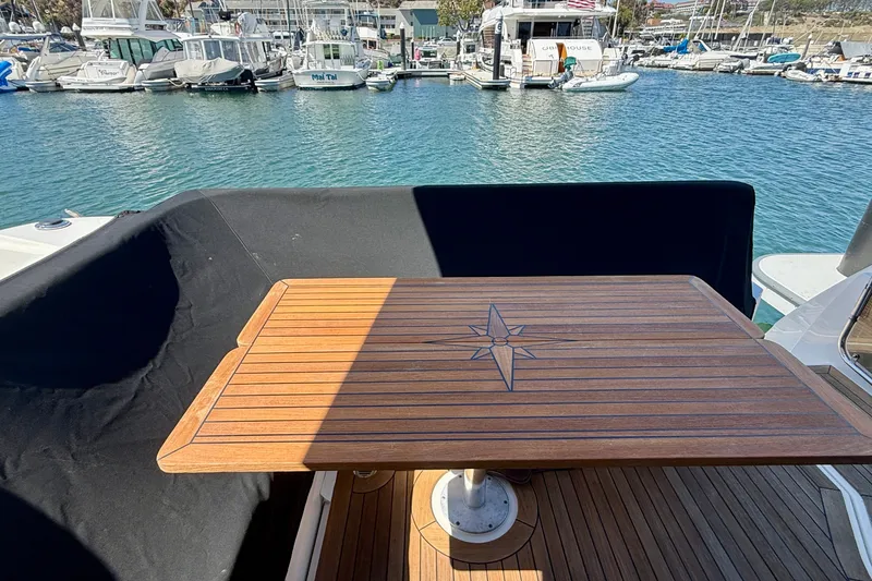 Slide: The Image of 2016 Sea Ray Sundancer 400 yacht with wooden deck table, docked at marina. - 49