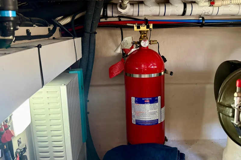 Slide: The Image of Fire extinguisher in 2016 Sea Ray Sundancer 400 engine room, surrounded by wiring and equipment. - 71