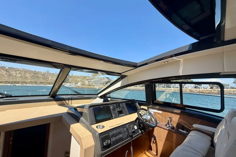 Slide: The Image of Interior view of 2016 Sea Ray Sundancer 400 yacht cockpit with panoramic windows. - 27