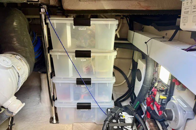 Slide: The Image of Storage area in a 2016 Sea Ray Sundancer 400 with organized plastic containers and boat equipment. - 67