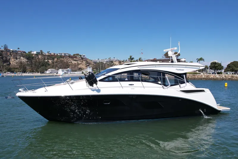 Slide: The Image of 2016 Sea Ray Sundancer 400 yacht cruising in a scenic coastal area. - 1