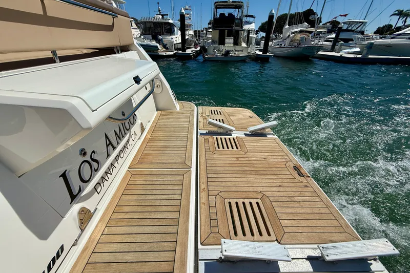 Slide: The Image of 2016 Sea Ray Sundancer 400 yacht docked at marina, featuring teak swim platform. - 51