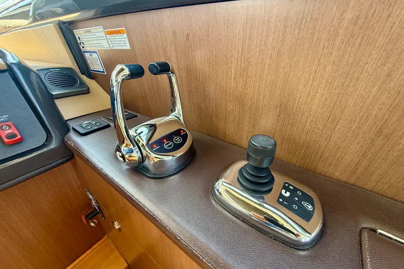 Slide: The Image of Control panel of a 2016 Sea Ray Sundancer 400 yacht with throttle and joystick. - 30