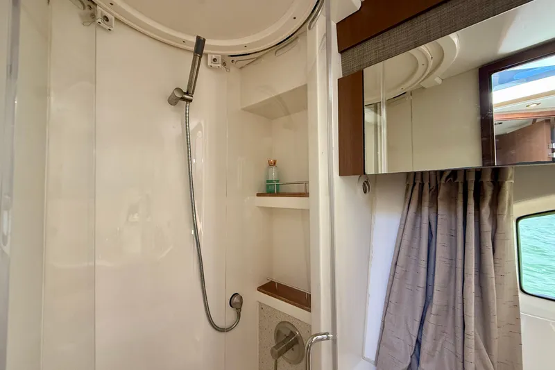 Slide: The Image of Shower area in 2016 Sea Ray Sundancer 400 yacht, featuring modern fixtures and storage shelves. - 42