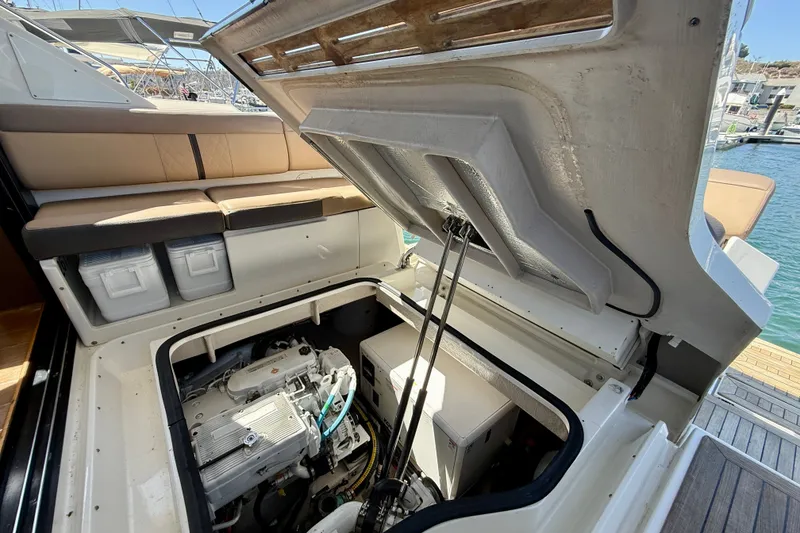Slide: The Image of Engine compartment of 2016 Sea Ray Sundancer 400 yacht, open hatch, marina background. - 64