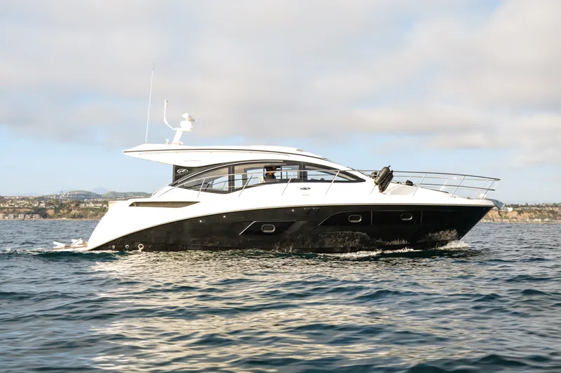 The Image of 2016 Sea Ray Sundancer 400 yacht cruising on open water under a cloudy sky. - 0