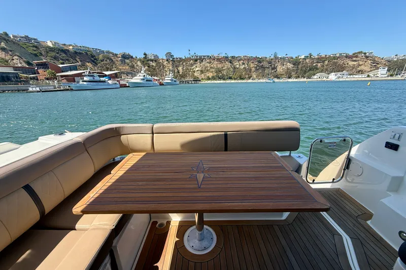 Slide: The Image of Luxurious 2016 Sea Ray Sundancer 400 yacht with elegant deck seating and scenic harbor view. - 48