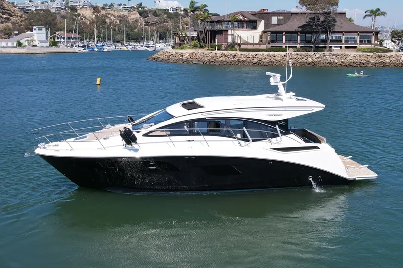 Slide: The Image of 2016 Sea Ray Sundancer 400 yacht cruising in a scenic marina setting. - 4