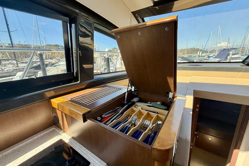 Slide: The Image of Interior of 2016 Sea Ray Sundancer 400 yacht with open cutlery drawer and marina view. - 26