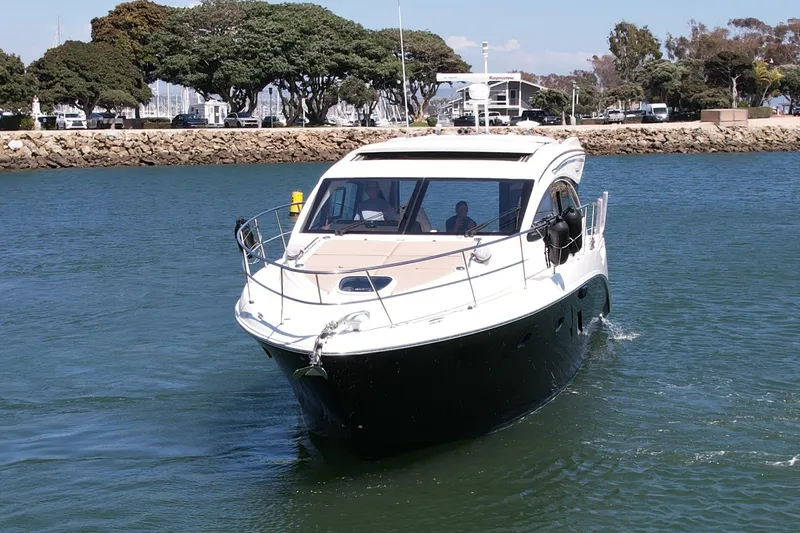 Slide: The Image of 2016 Sea Ray Sundancer 400 yacht cruising in a serene harbor setting. - 8
