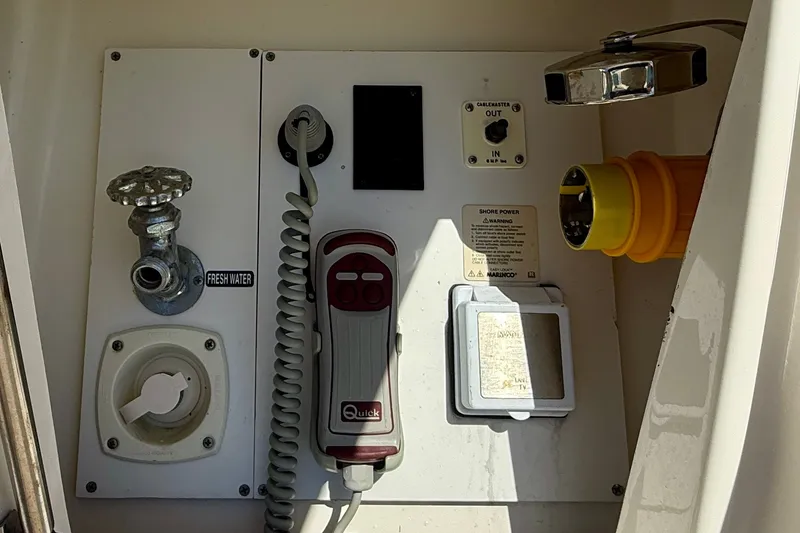 Slide: The Image of Control panel of a 2016 Sea Ray Sundancer 400 yacht, featuring fresh water and shore power connections. - 54