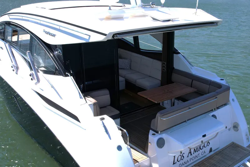 Slide: The Image of 2016 Sea Ray Sundancer 400 yacht with spacious seating area on calm water. - 6