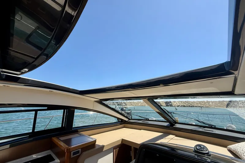 Slide: The Image of Interior view of 2016 Sea Ray Sundancer 400 yacht with open sunroof and ocean backdrop. - 36