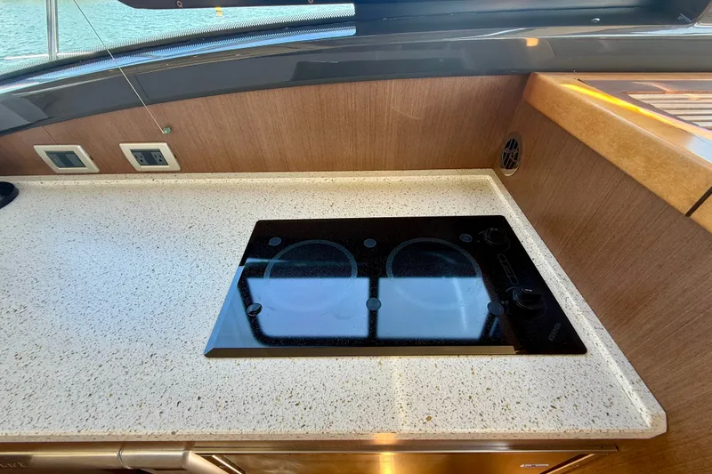 Slide: The Image of Modern kitchen countertop with electric stove on 2016 Sea Ray Sundancer 400 yacht. - 22