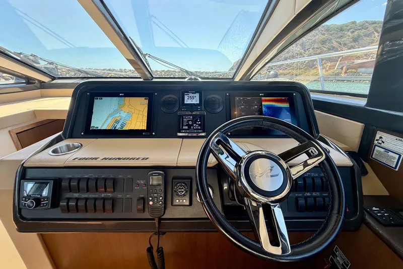 Slide: The Image of Helm of 2016 Sea Ray Sundancer 400 with navigation displays and steering wheel. - 29