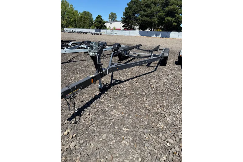 Slide: The Image of Trailer for 2021 Bayliner VR6 Bowrider I/O on gravel lot, surrounded by trees. - 19