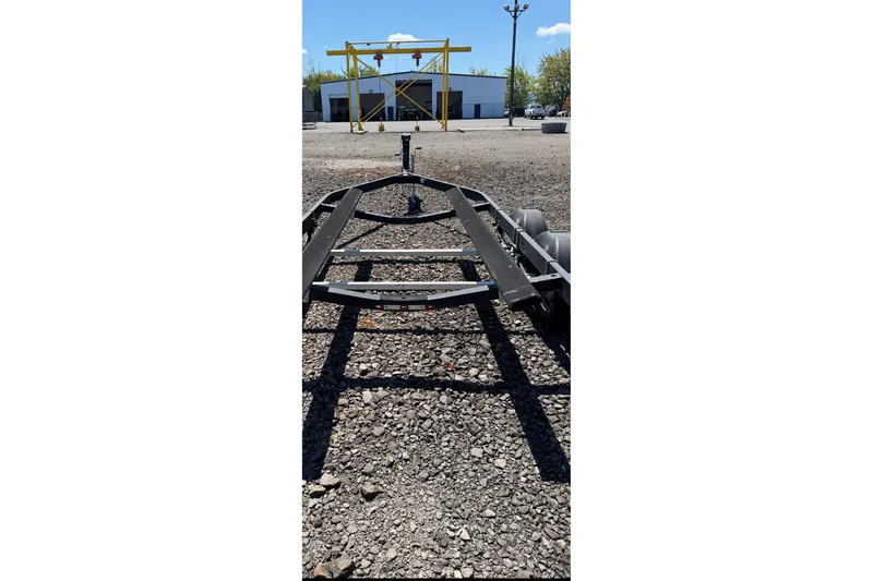 Slide: The Image of Empty boat trailer for 2021 Bayliner VR6 Bowrider I/O on gravel lot. - 21