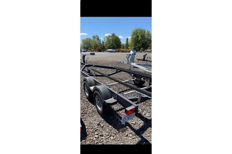 Slide: The Image of Trailer for 2021 Bayliner VR6 Bowrider I/O on gravel lot, sunny day. - 23