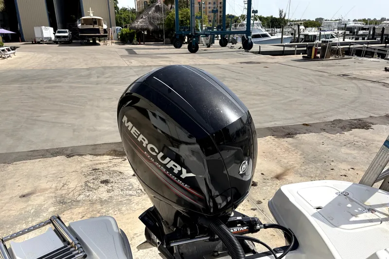 Slide: The Image of Mercury outboard motor on a 2019 Tahoe 550 TS boat at a marina. - 8