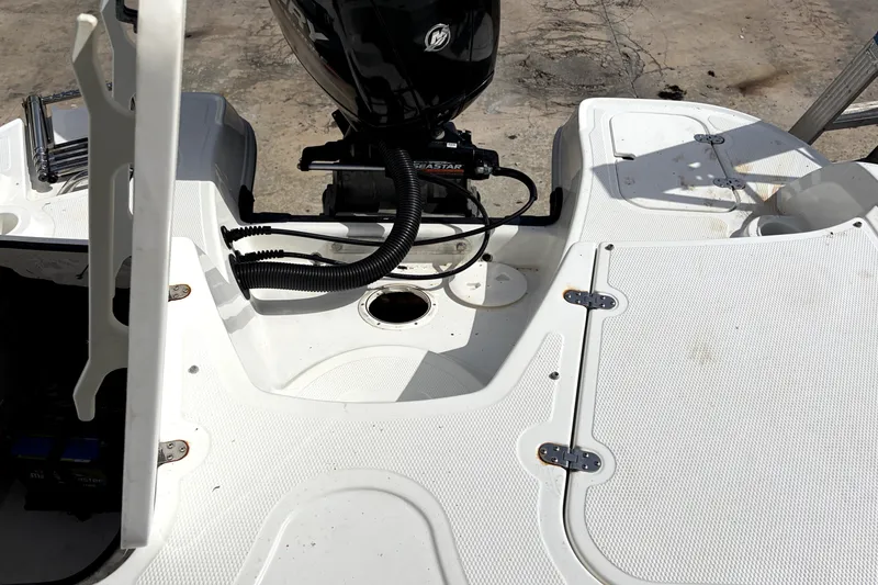 Slide: The Image of 2019 Tahoe 550 TS boat deck with motor and storage compartments. - 10