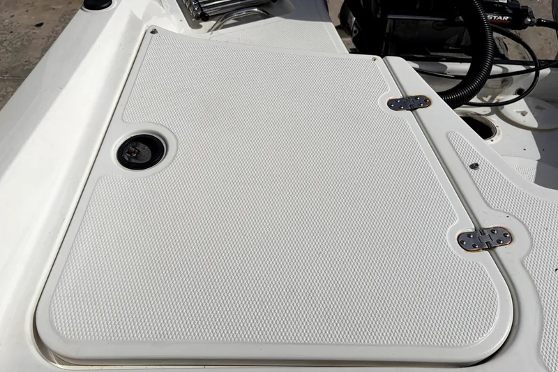 Slide: The Image of 2019 Tahoe 550 TS boat deck with textured surface and metal hinges. - 11