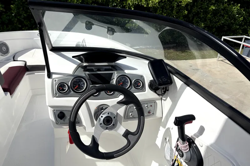 Slide: The Image of 2019 Tahoe 550 TS boat dashboard with steering wheel and control panel. - 17