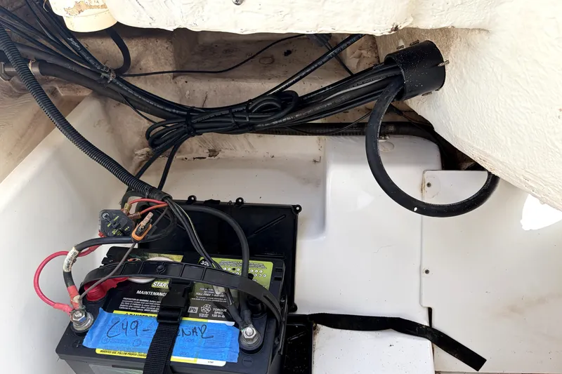 Slide: The Image of Battery compartment of a 2019 Tahoe 550 TS boat with wiring and cables. - 18