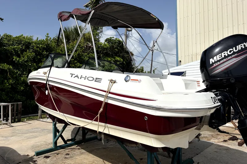 Slide: The Image of 2019 Tahoe 550 TS boat with Mercury engine, docked outdoors. - 5