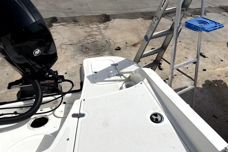 Slide: The Image of 2019 Tahoe 550 TS boat with outboard motor and ladder on concrete surface. - 14