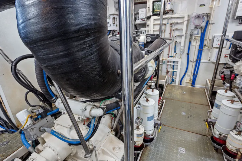 Slide: The Image of Engine room of 2005 Offshore Yachts 66 Pilot House, showcasing machinery and piping. - 51