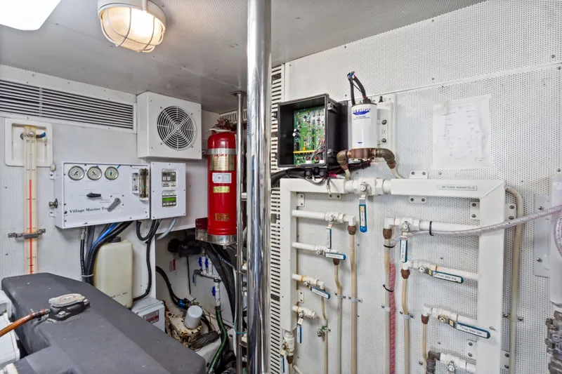 Slide: The Image of Engine room of 2005 Offshore Yachts 66 Pilot House with control panels and piping. - 48