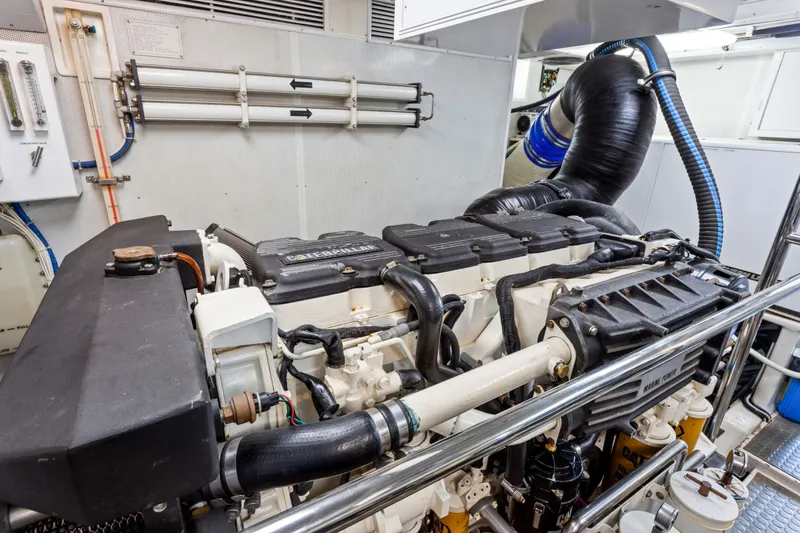 Slide: The Image of Engine room of 2005 Offshore Yachts 66 Pilot House, featuring Caterpillar marine engine. - 45