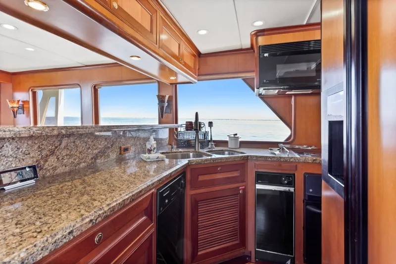 Slide: The Image of Luxurious kitchen interior of 2005 Offshore Yachts 66 Pilot House with ocean view. - 12