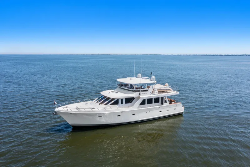 Slide: The Image of 2005 Offshore Yachts 66 Pilot House cruising on open water under clear blue skies. - 4