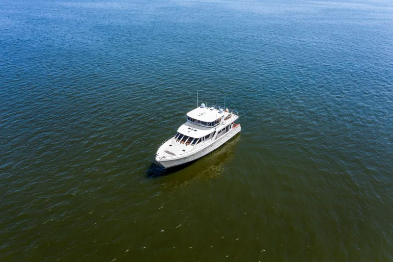 Slide: The Image of 2005 Offshore Yachts 66 Pilot House cruising on open water. - 56