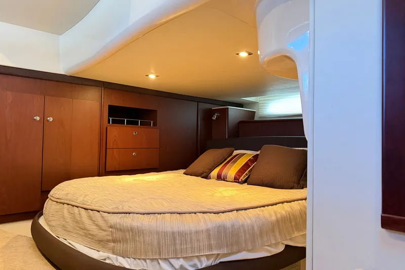 Slide: The Image of The image shows a luxurious cabin with a large bed, wooden furniture, and soft lighting. - 30