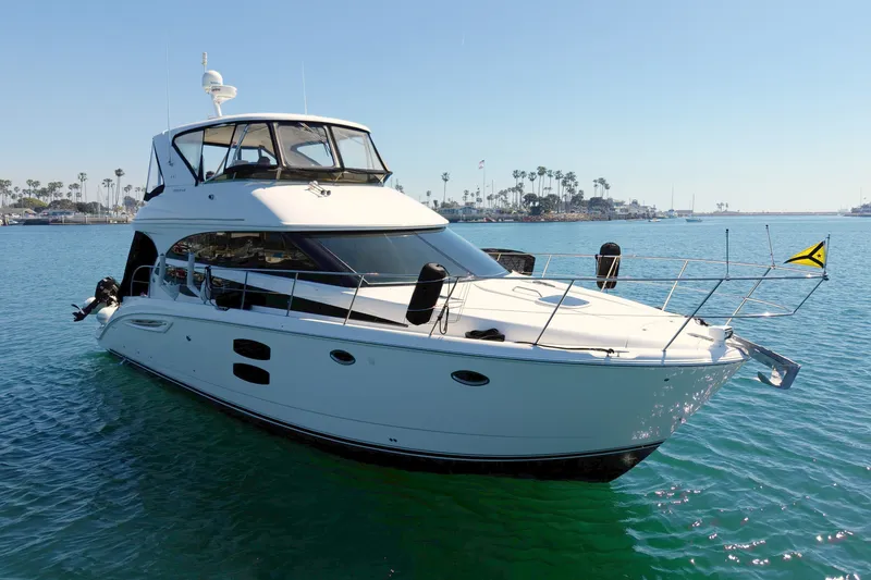 Slide: The Image of A 2014 Meridian 441 Sedan yacht on calm water with a clear sky in the background. - 4
