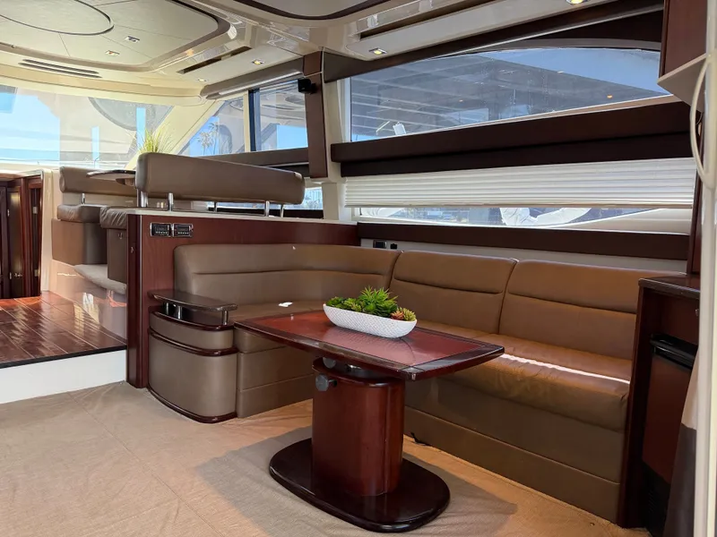 Slide: The Image of Interior of a 2014 Meridian 441 Sedan with elegant leather seating and a wooden table. - 10