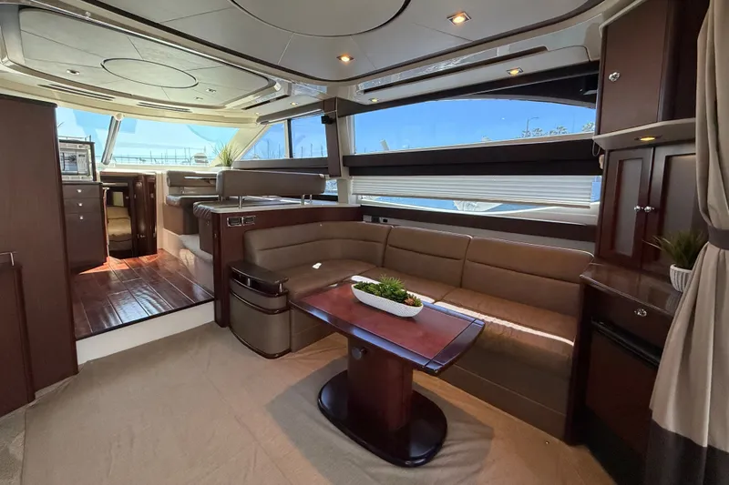 Slide: The Image of The interior of a 2014 Meridian 441 Sedan features an elegant seating area with a wooden table and large windows. - 9