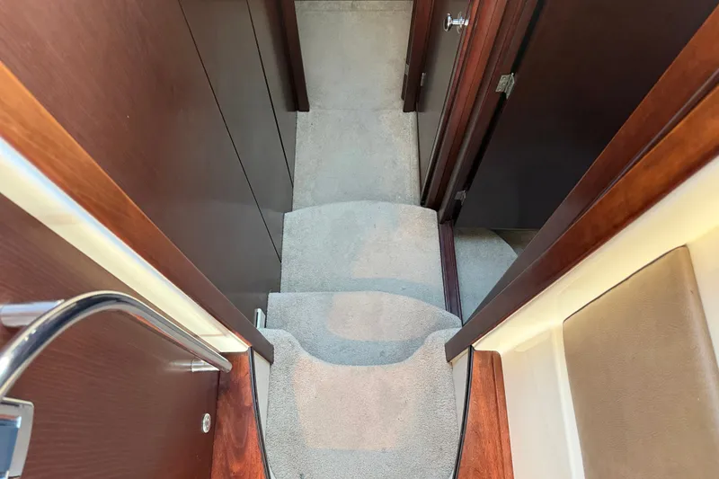 Slide: The Image of Carpeted stairs inside a 2014 Meridian 441 Sedan with wooden walls. - 21