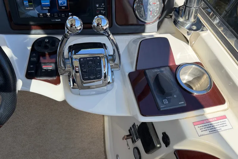 Slide: The Image of The image shows the helm of a 2014 Meridian 441 Sedan with control levers and instruments. - 49