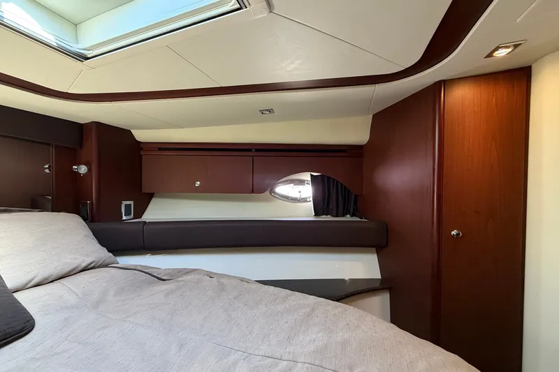 Slide: The Image of Interior of a 2014 Meridian 441 Sedan featuring a cozy bed and wood paneling. - 25