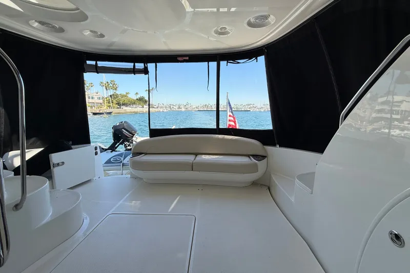 Slide: The Image of The image shows the aft of a 2014 Meridian 441 Sedan with seating area and water view. - 6
