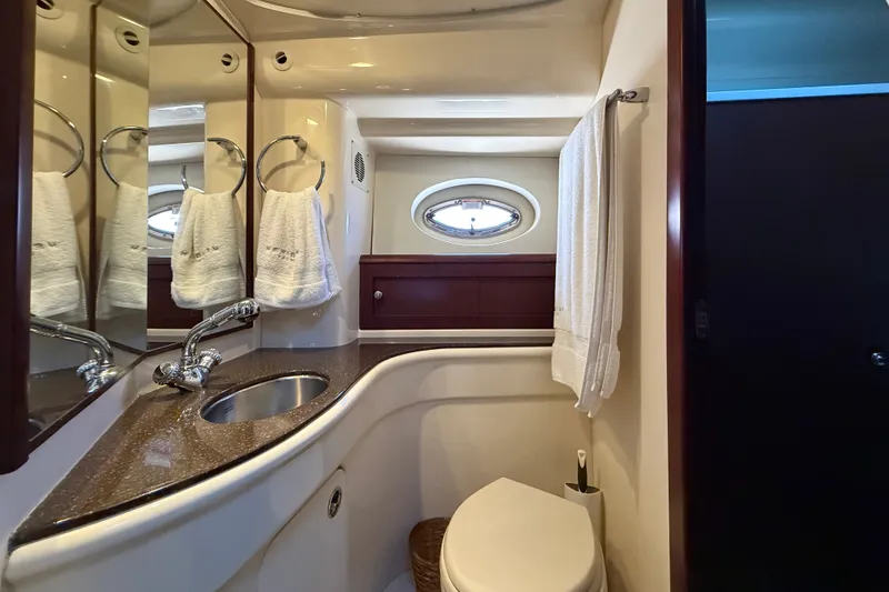 Slide: The Image of The image shows an elegant yacht bathroom with a sink, toilet, and towel holder. - 35