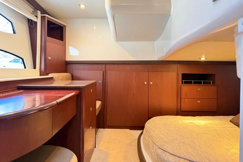 Slide: The Image of Interior of a 2014 Meridian 441 Sedan with wooden cabinetry and a cozy bed. - 29