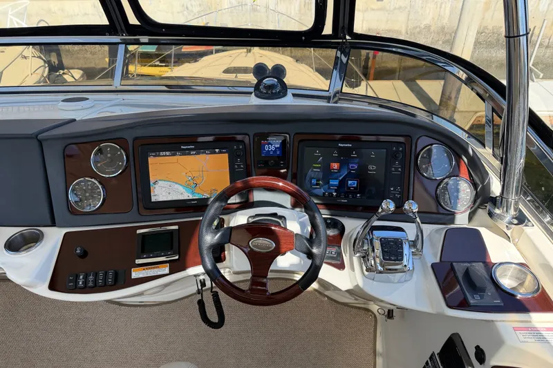 Slide: The Image of The image shows the helm of a 2014 Meridian 441 Sedan with modern navigation systems. - 48